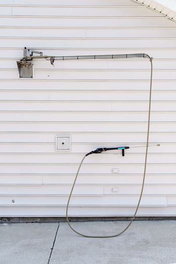 A hose plugged into the side of a garage door